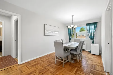 a view of a dining room with furniture and chandelier