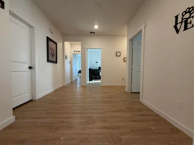 a view of a big room with wooden floor and bathroom