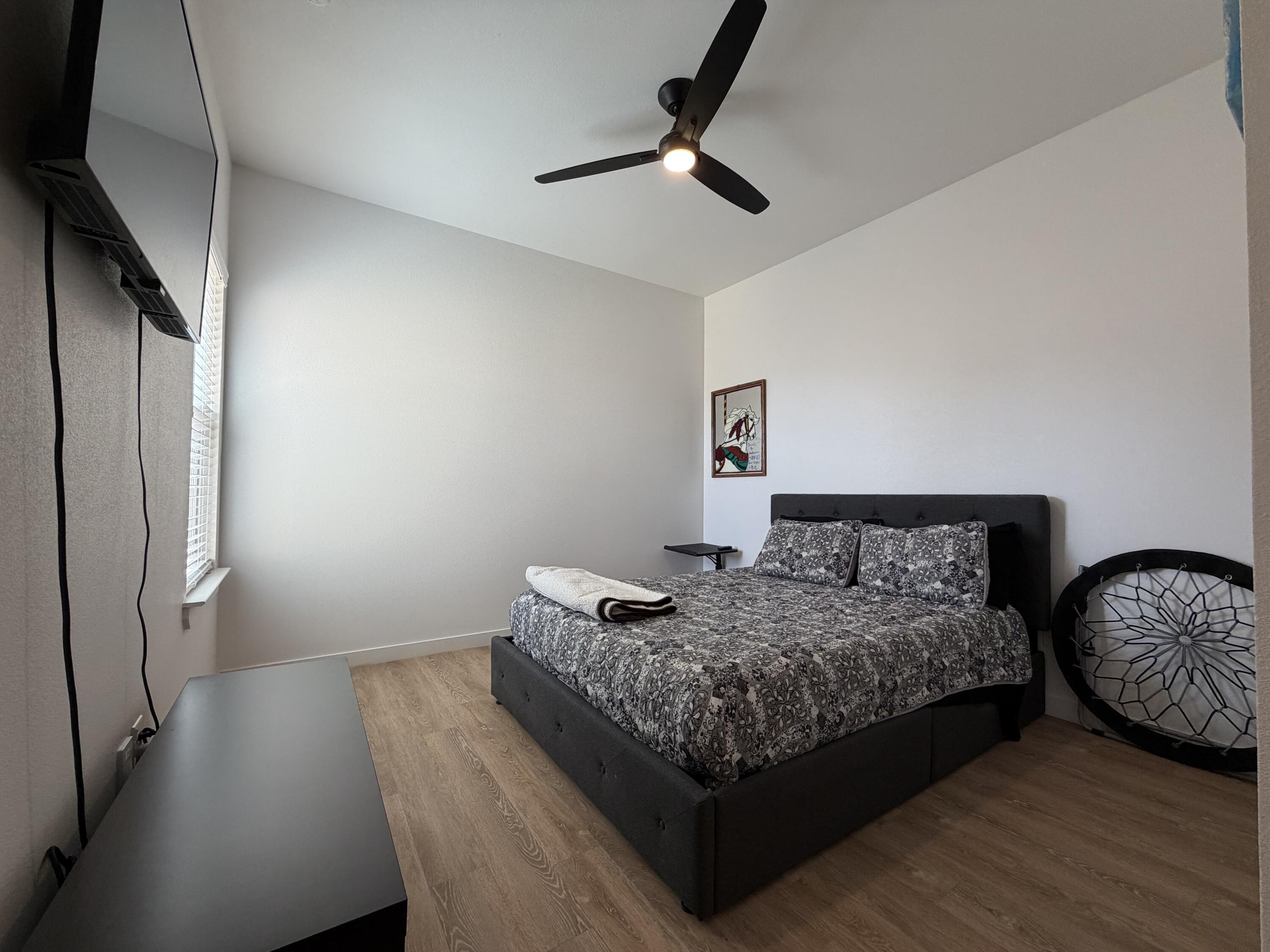 5807 Virginia Avenue Lubbock, TX 79407 - Photo 15 of 26 a bedroom with bed and wooden floor