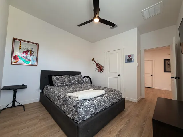 a bedroom with a bed and a chandelier