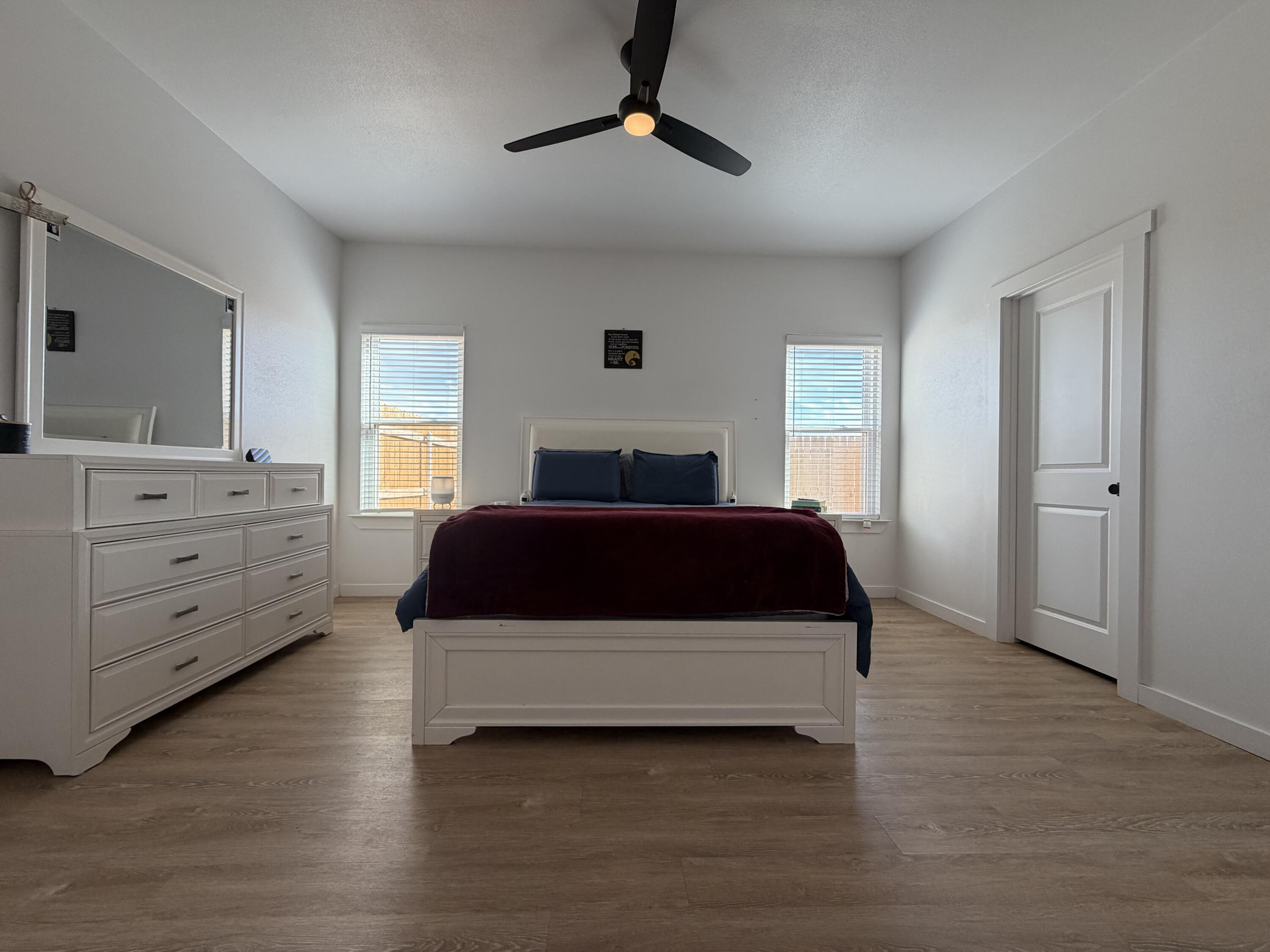5807 Virginia Avenue Lubbock, TX 79407 - Photo 21 of 26 a bedroom with a bed and a dresser
