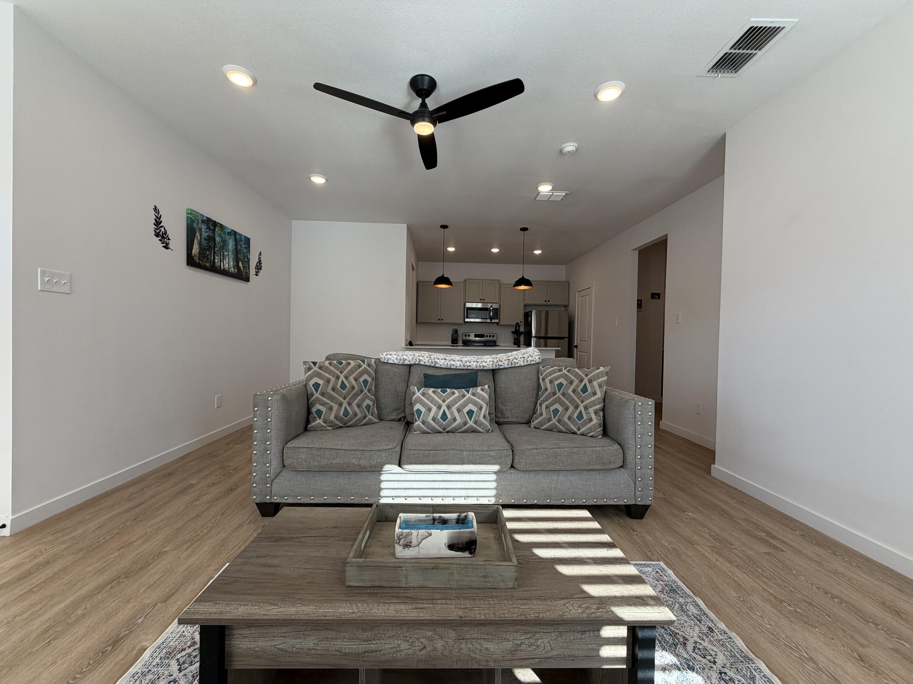 5807 Virginia Avenue Lubbock, TX 79407 - Photo 7 of 26 a living room with furniture and a wooden floor