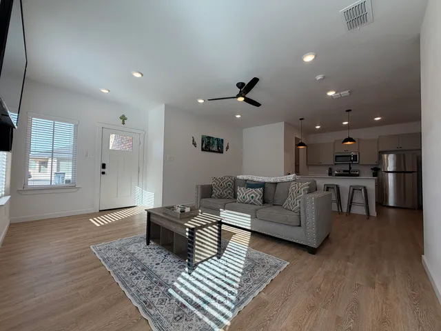 a living room with furniture and a wooden floor