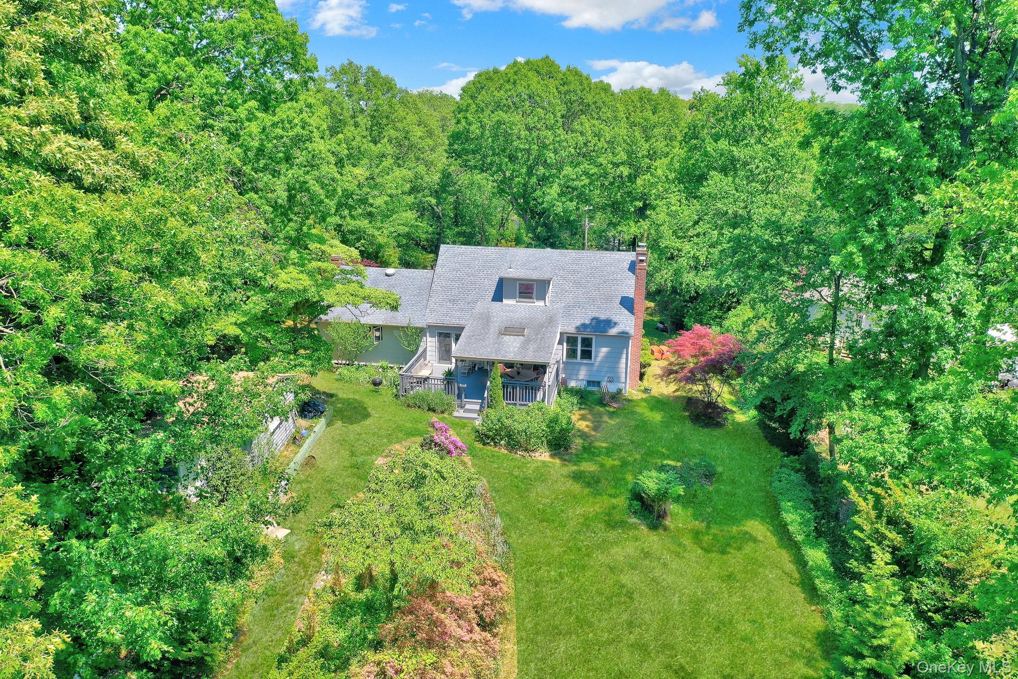 100 Elwood Road Northport, NY 11768 - Photo 28 of 39 Shingle-style residence featuring a dormer window, covered porch, and a brick chimney