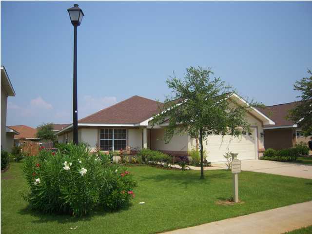 75 Red Maple Court Santa Rosa Beach, FL 32459 - Photo 1 of 8 a front view of a house with a yard