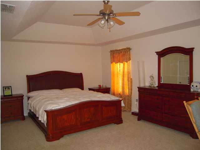 75 Red Maple Court Santa Rosa Beach, FL 32459 - Photo 2 of 8 a bedroom with a bed mirror and window
