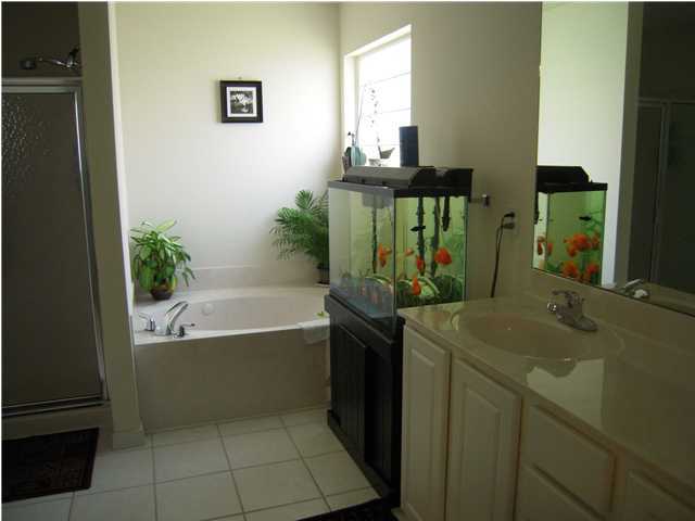 75 Red Maple Court Santa Rosa Beach, FL 32459 - Photo 3 of 8 a bathroom with a tub sink and mirror