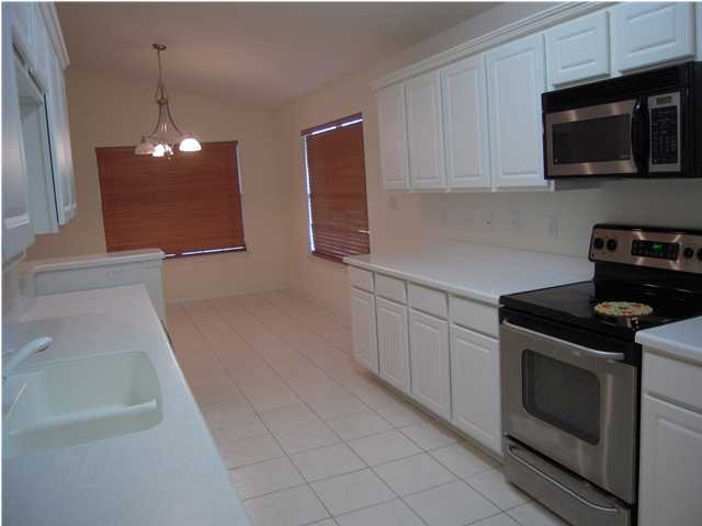 75 Red Maple Court Santa Rosa Beach, FL 32459 - Photo 4 of 8 a kitchen with stainless steel appliances granite countertop a sink a stove a microwave and cabinets