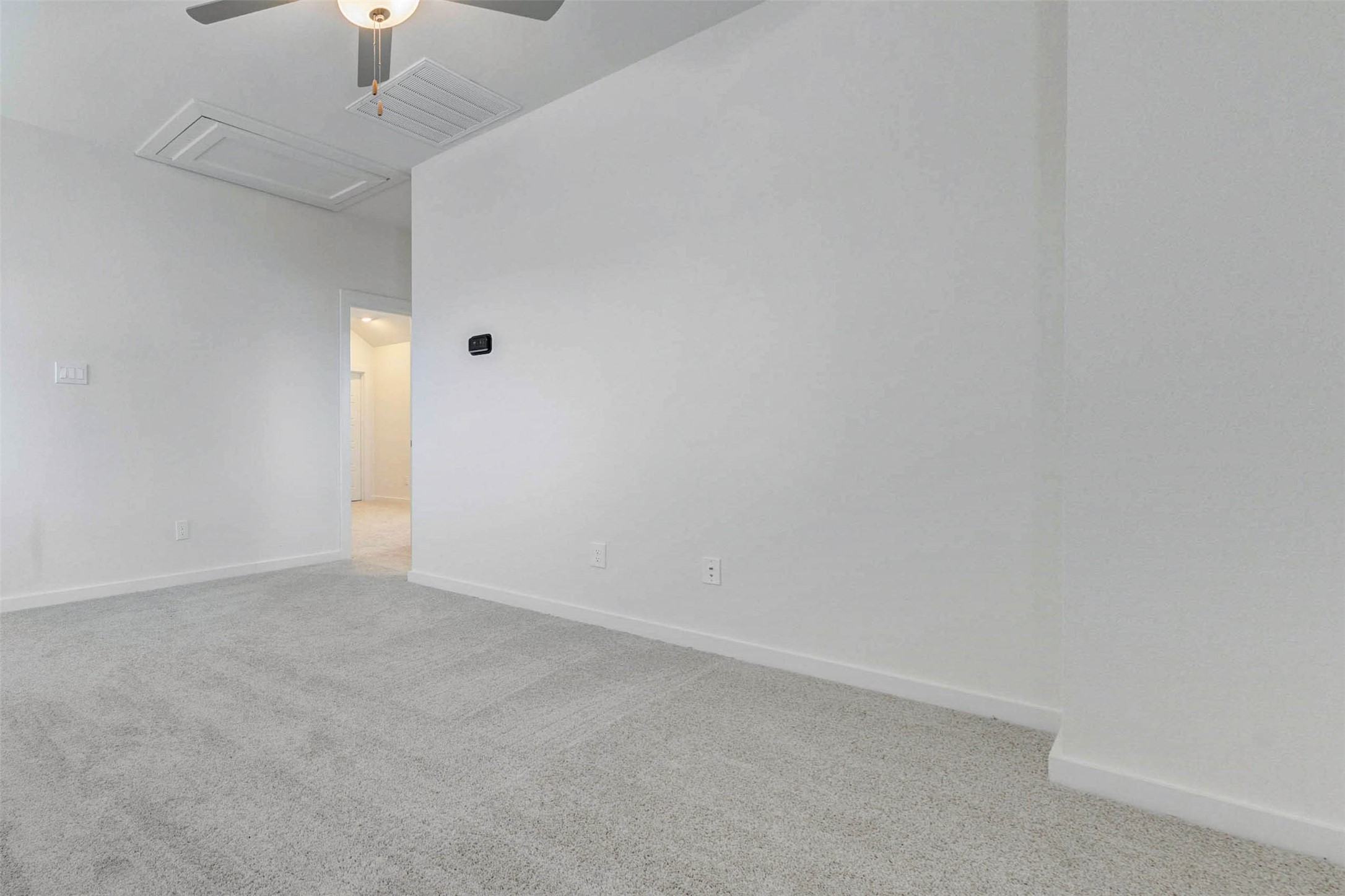6471 Escondido Drive Rosharon, TX 77583 - Photo 25 of 33 Spacious secondary bedroom with soft carpet, neutral walls, ceiling fan, and a clean open layout ready for personal style. The room offers flexibility for a guest suite, child’s room, office, or hobby space, with easy access to the hallway and a bright, comfortable feel.