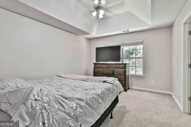 a bathroom with a granite countertop sink a mirror and a bathtub