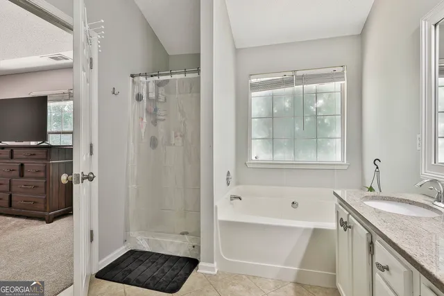 a bathroom with a sink vanity and mirror