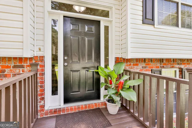 a potted plant is sitting in front of a house