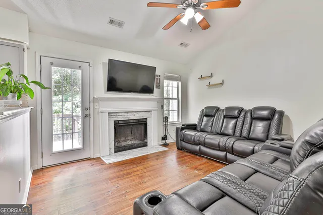a living room with furniture and a fireplace