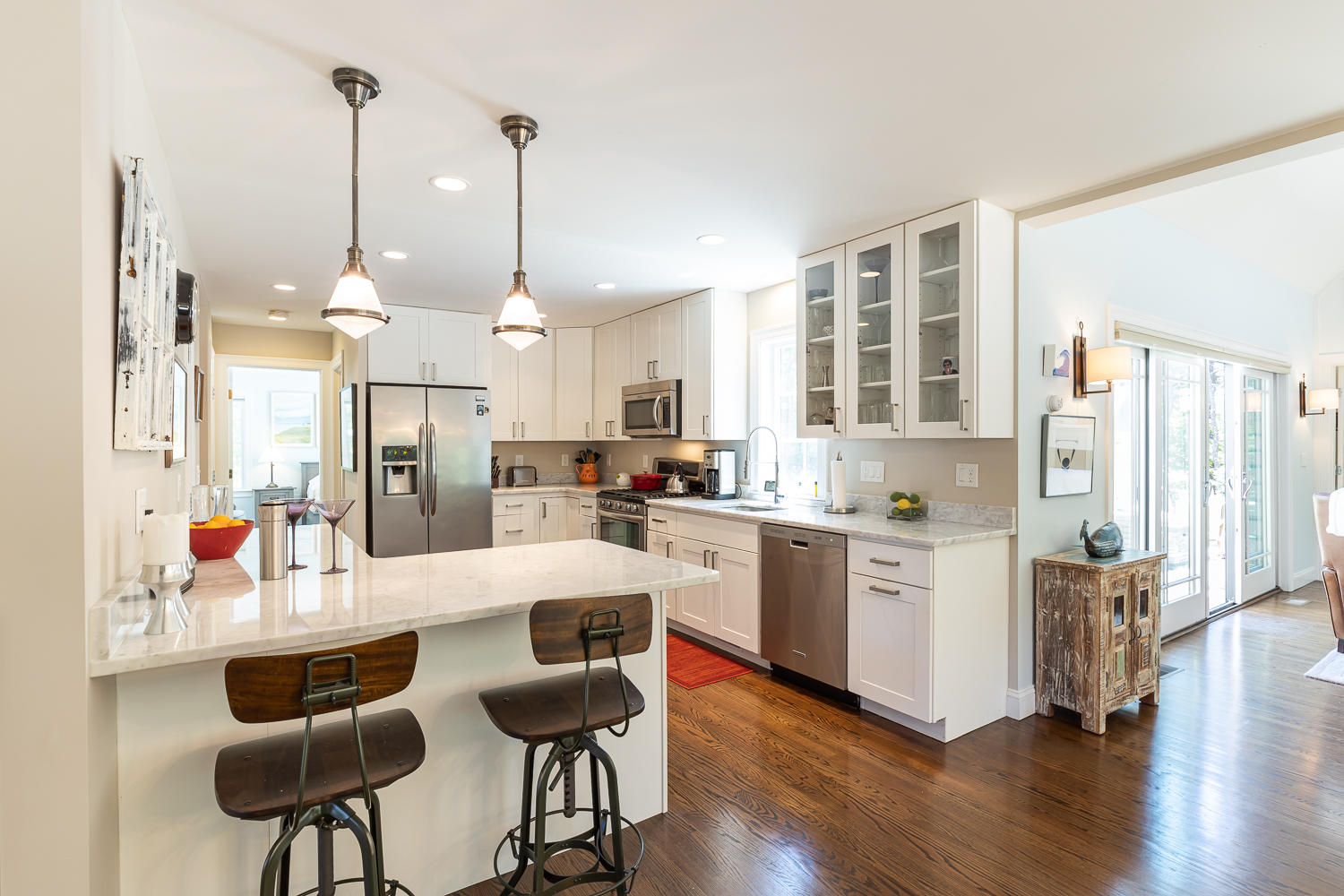 1 Yellow Brick Road Truro, MA 02666 - Photo 17 of 34 a large kitchen with white cabinets and stainless steel appliances