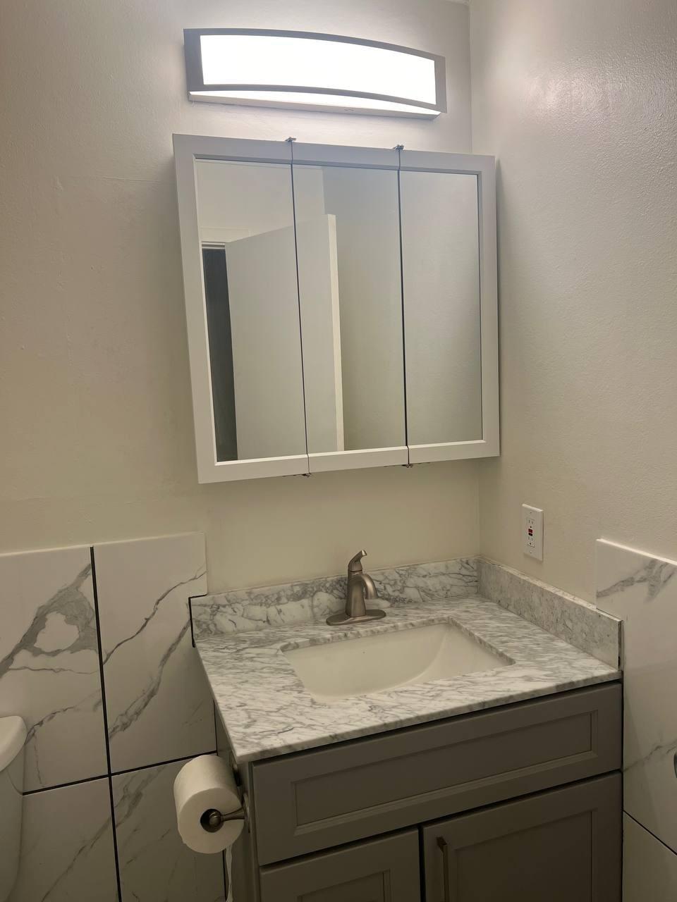 1300 Regency Way, Unit 44 Tahoe Vista, CA 96148 - Photo 13 of 25 a bathroom with a granite countertop sink and a mirror