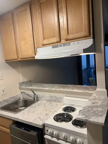 a kitchen with a sink and cabinets