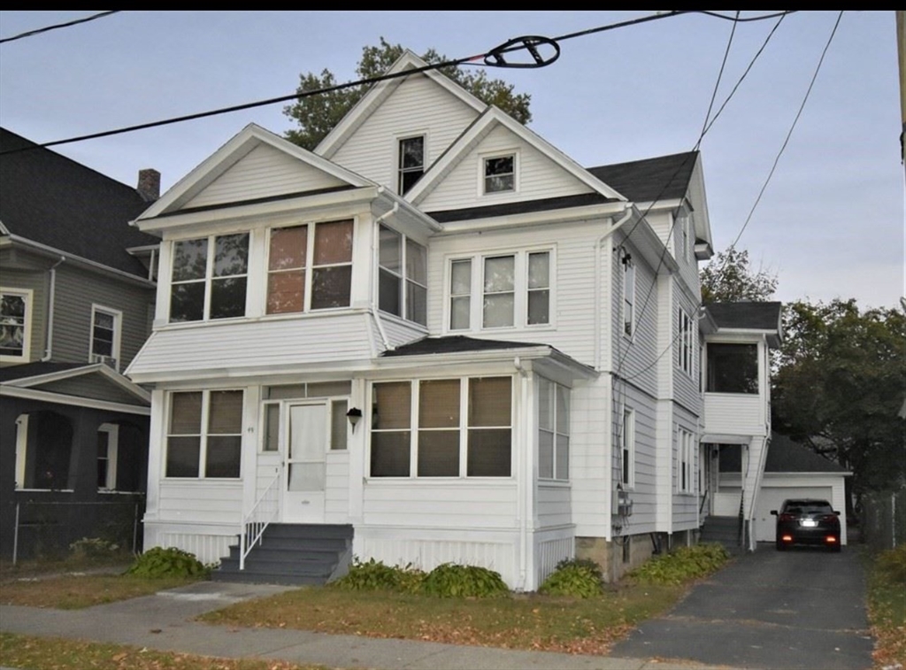 a car parked in front of a white house