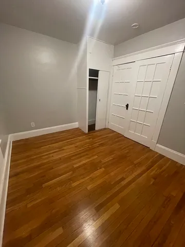 an empty room with wooden floor
