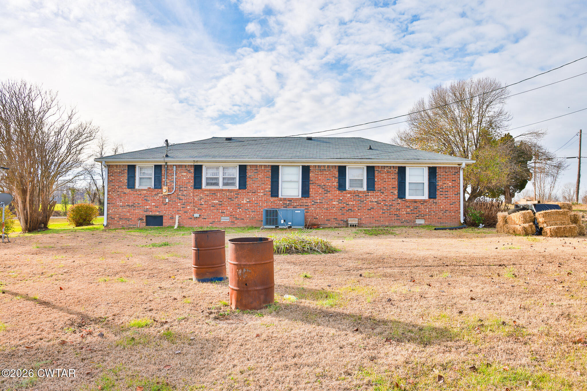 32 New Hope Road Dyer, TN 38330 - Photo 12 of 28 a front view of a house with a yard covered with snow and trees