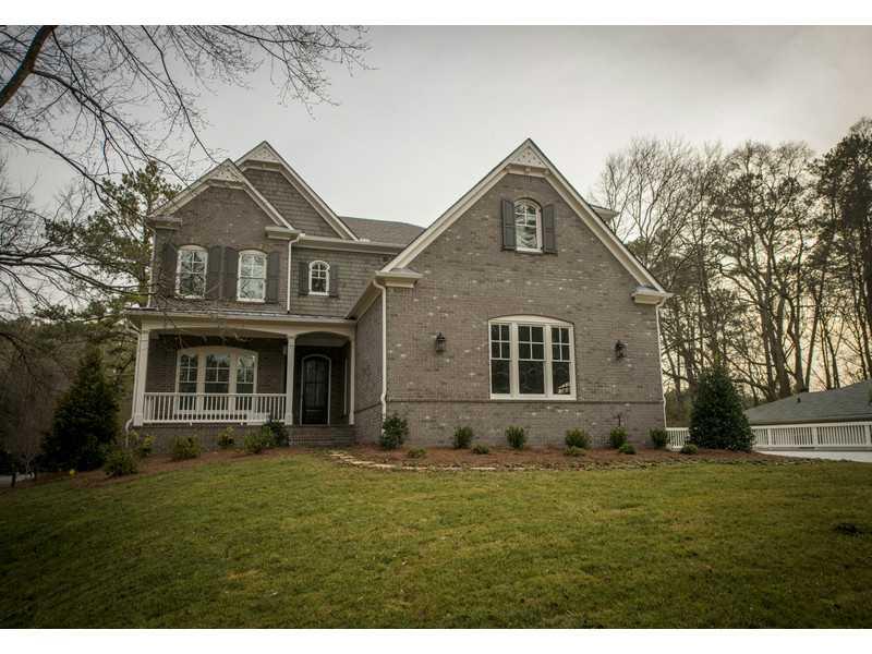 755 East Powderhorn Road Northeast Atlanta, GA 30342 - Photo 1 of 1 a front view of a house with a yard and garage