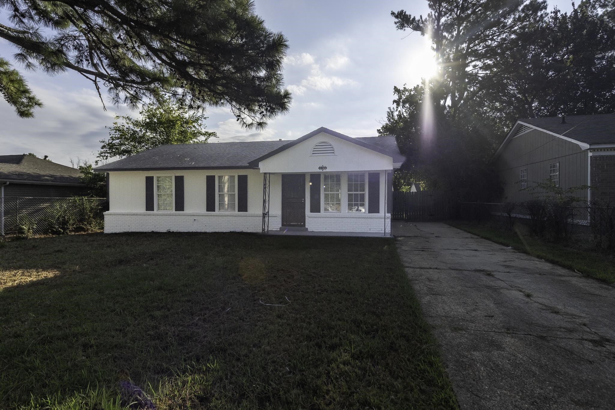 4780 Hillbrook Road Memphis, TN 38109 - Photo 3 of 25 White exterior with dark shutters, gabled roofline, front porch, and paved driveway