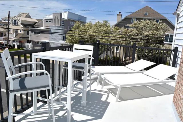 a view of a patio with table and chairs barbeque with wooden floor