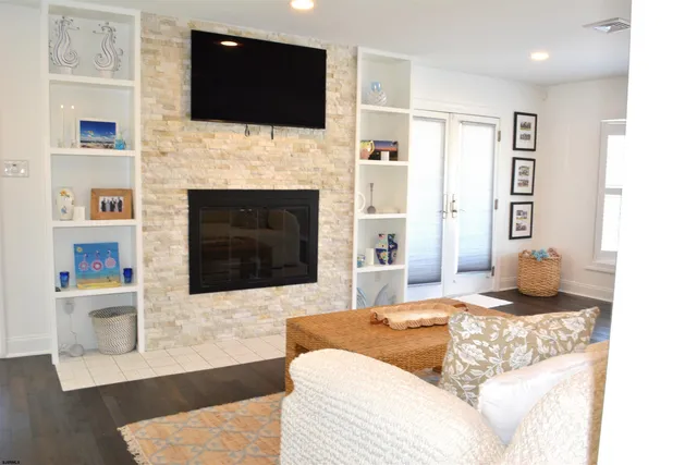 a living room with fireplace furniture and a flat screen tv