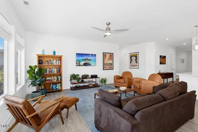 a living room with furniture and a bookshelf