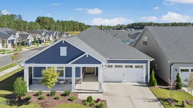 a aerial view of a house with table and chairs