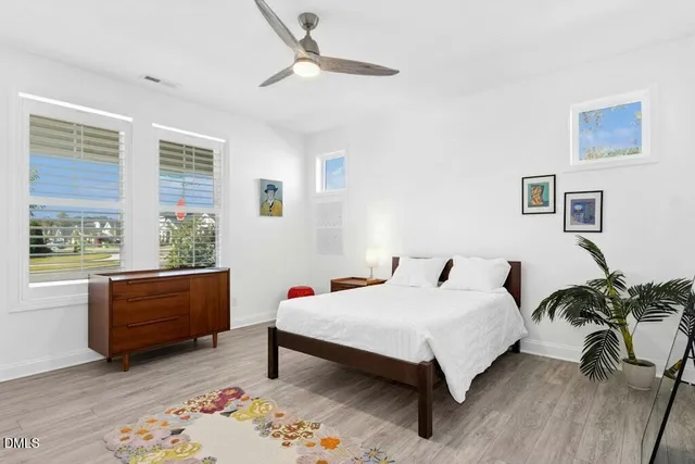 a bedroom with a bed a rug and a chair