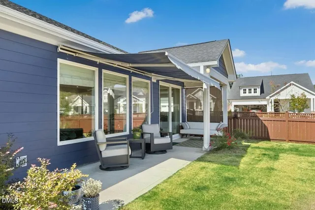 a view of a house with backyard porch and sitting area