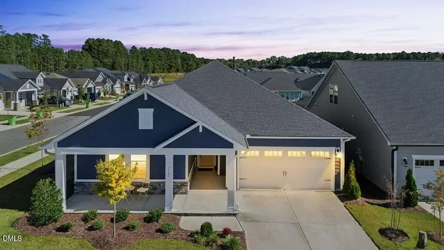 a aerial view of a house with a yard and balcony