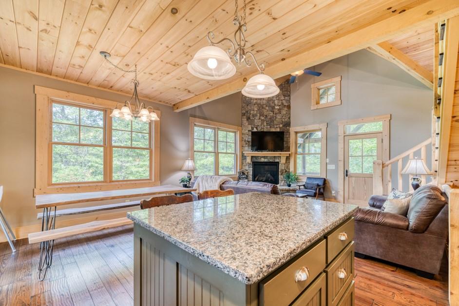 111 Watkins Farm Road Blue Ridge, GA 30513 - Photo 7 of 23 a kitchen with granite countertop a sink and a large window