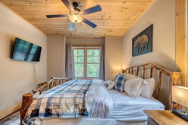 a bedroom with a bed and a flat screen tv
