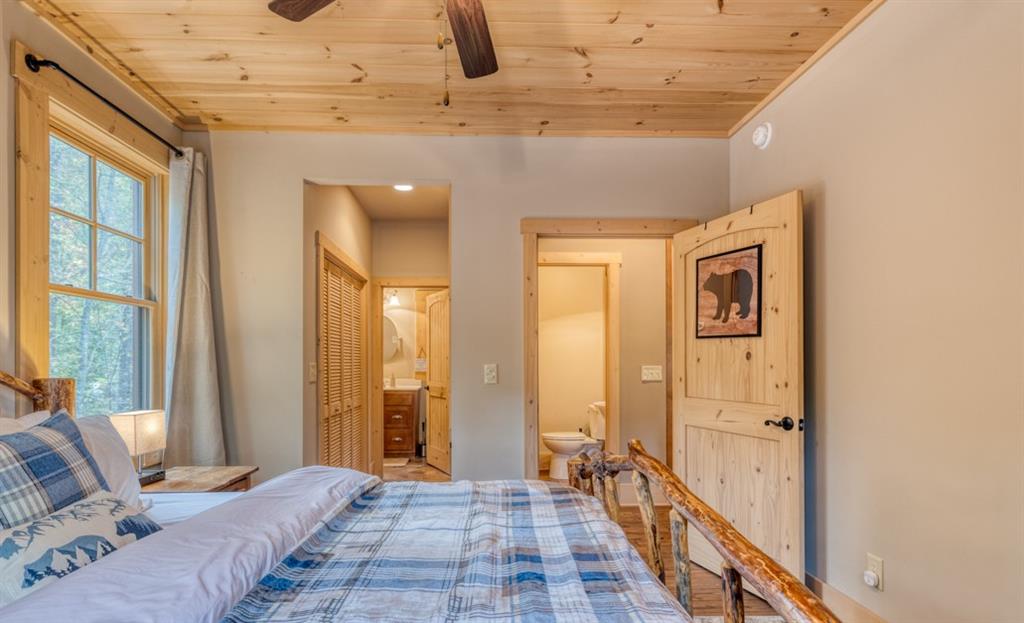 111 Watkins Farm Road Blue Ridge, GA 30513 - Photo 9 of 23 a bedroom with a bed and a large window