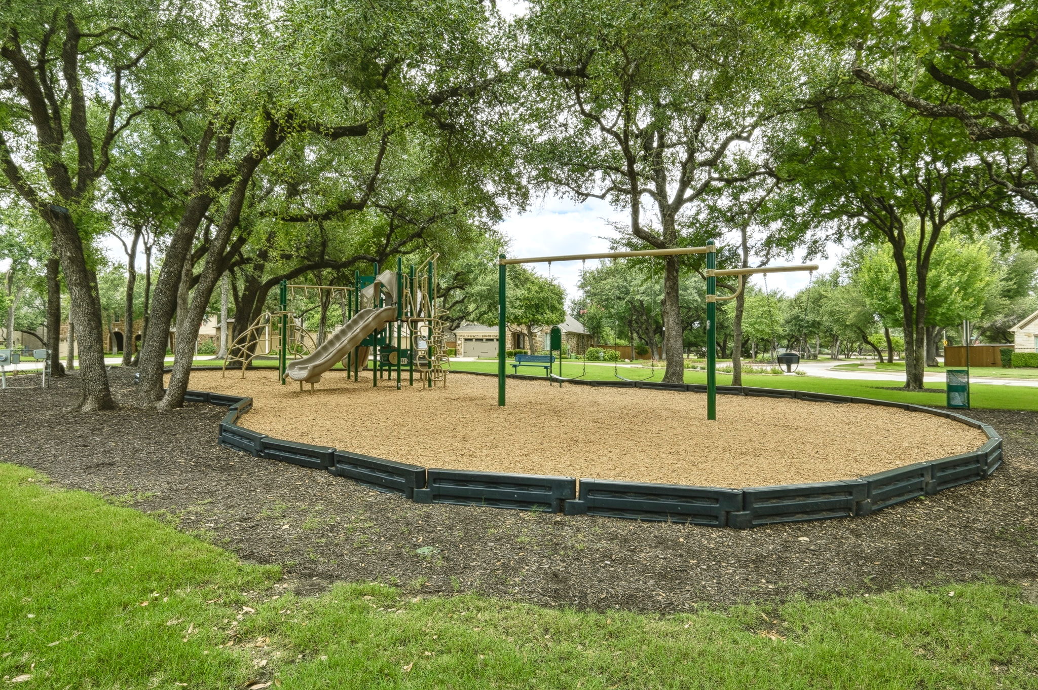 110 Dasher Drive Cedar Park, TX 78613 - Photo 35 of 39 Children's playground set within a community green space, nestled among mature trees.