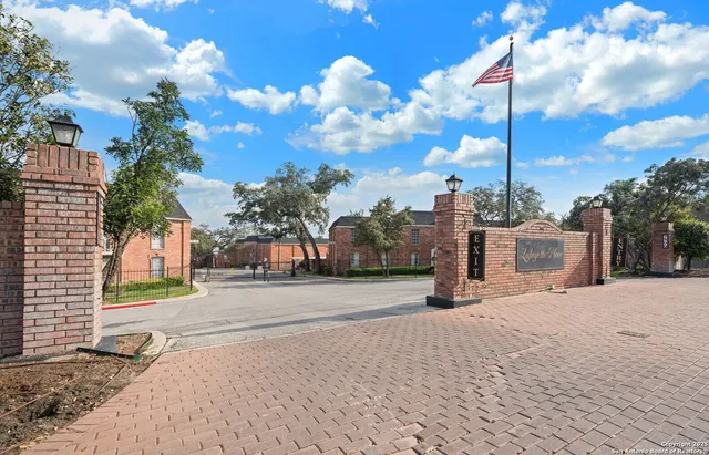 a view of a stone house with a snow in the background