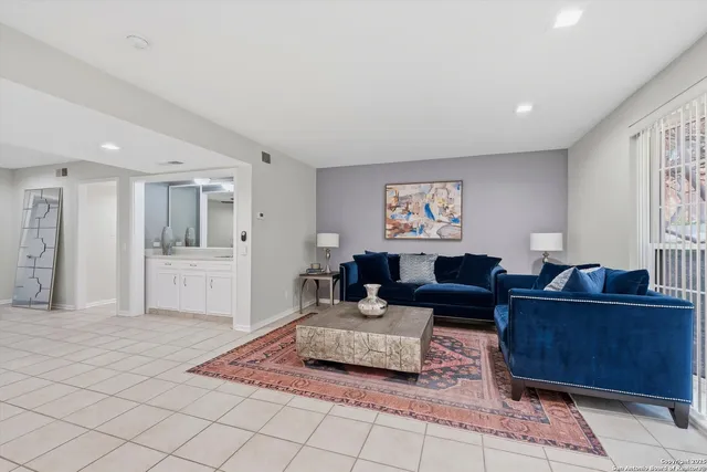 a living room with furniture and a rug