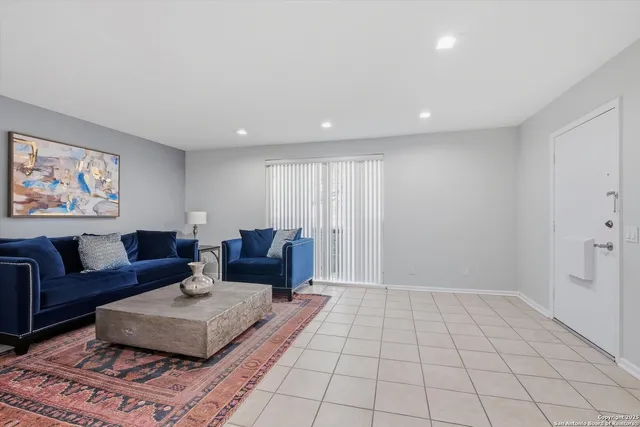 a spacious bathroom with a shower a mirror and a sink