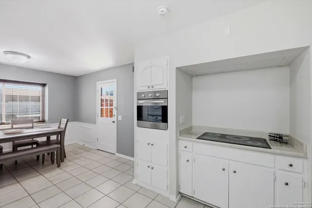 a view of a dining room with furniture and a chandelier