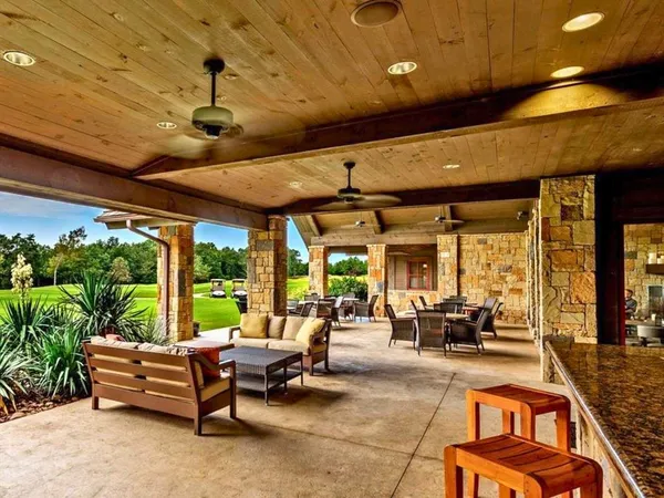 a living room with patio furniture and a potted plants
