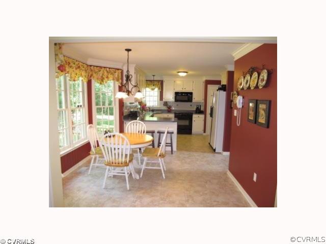 15219 Windy Ridge Road Midlothian, VA 23112 - Photo 2 of 12 a dining room with furniture and chandelier