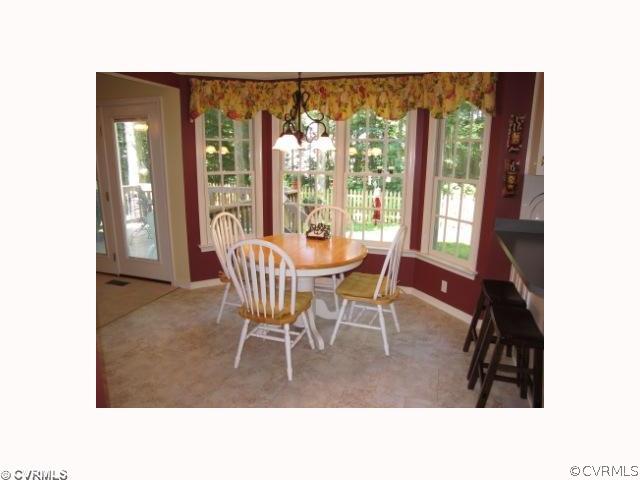 15219 Windy Ridge Road Midlothian, VA 23112 - Photo 3 of 12 a dining room with furniture and large windows