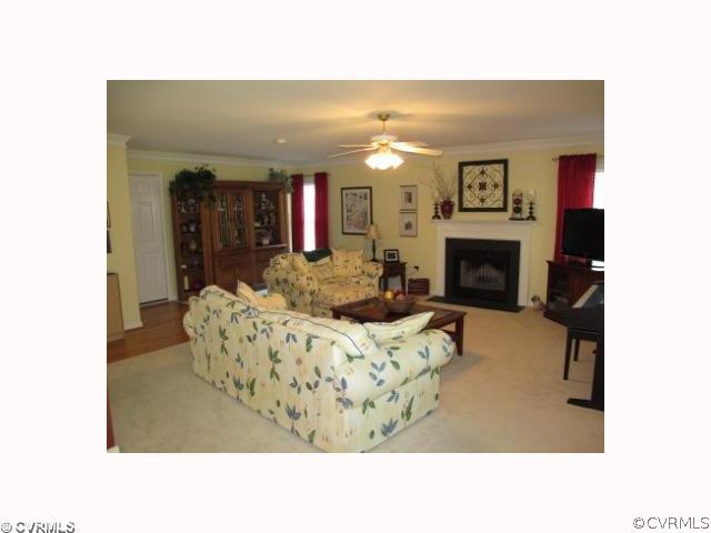 15219 Windy Ridge Road Midlothian, VA 23112 - Photo 5 of 12 a living room with furniture and a fireplace