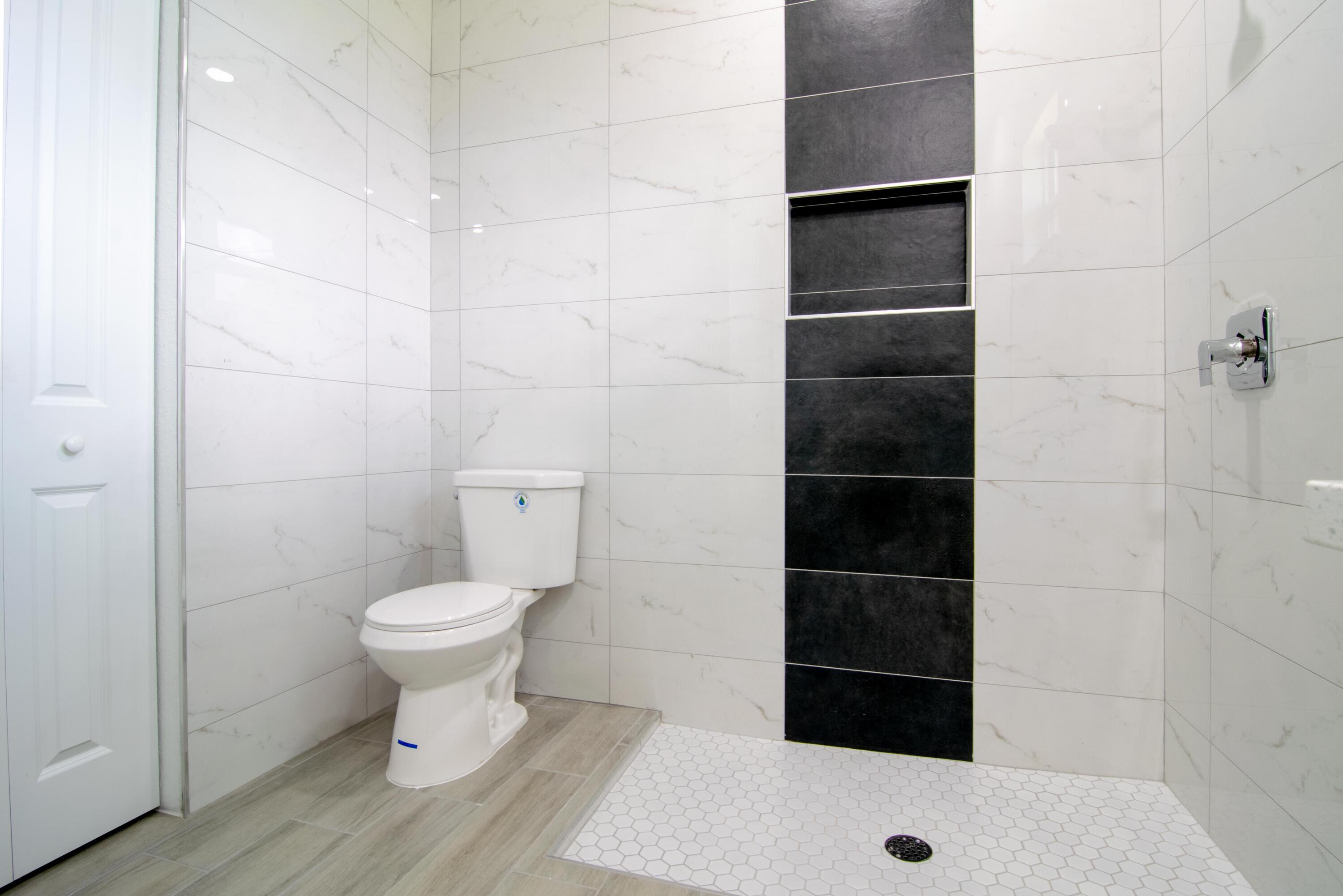 10654 Washington Road Port Charlotte, FL 33981 - Photo 21 of 36 a bathroom with a toilet and a shower