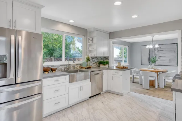 a kitchen with counter top space sink and refrigerator