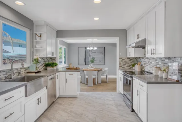 a large kitchen with cabinets and wooden floor