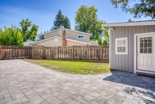 a view of a backyard with wooden fence