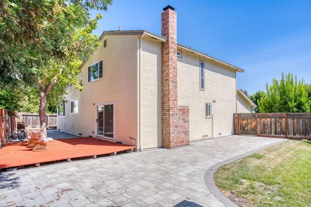a view of a house with backyard and sitting area