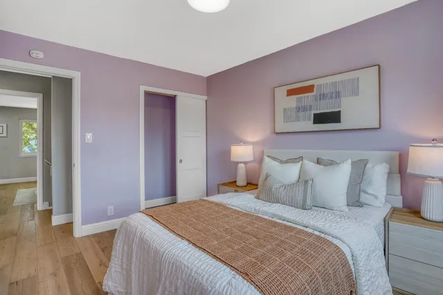 a bedroom with a bed and a painting